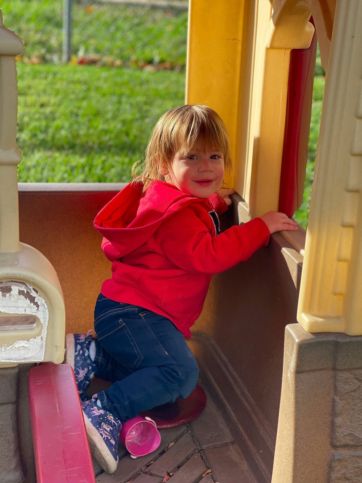 Enmerson joined the competition — help win amazing prizes! baby_toddler_clothing, child, door, finger, fun, happy, human_leg, human_settlement, leisure, magenta, person, pink, plant, play, public_space, sitting, smile, sock, standing, toddler