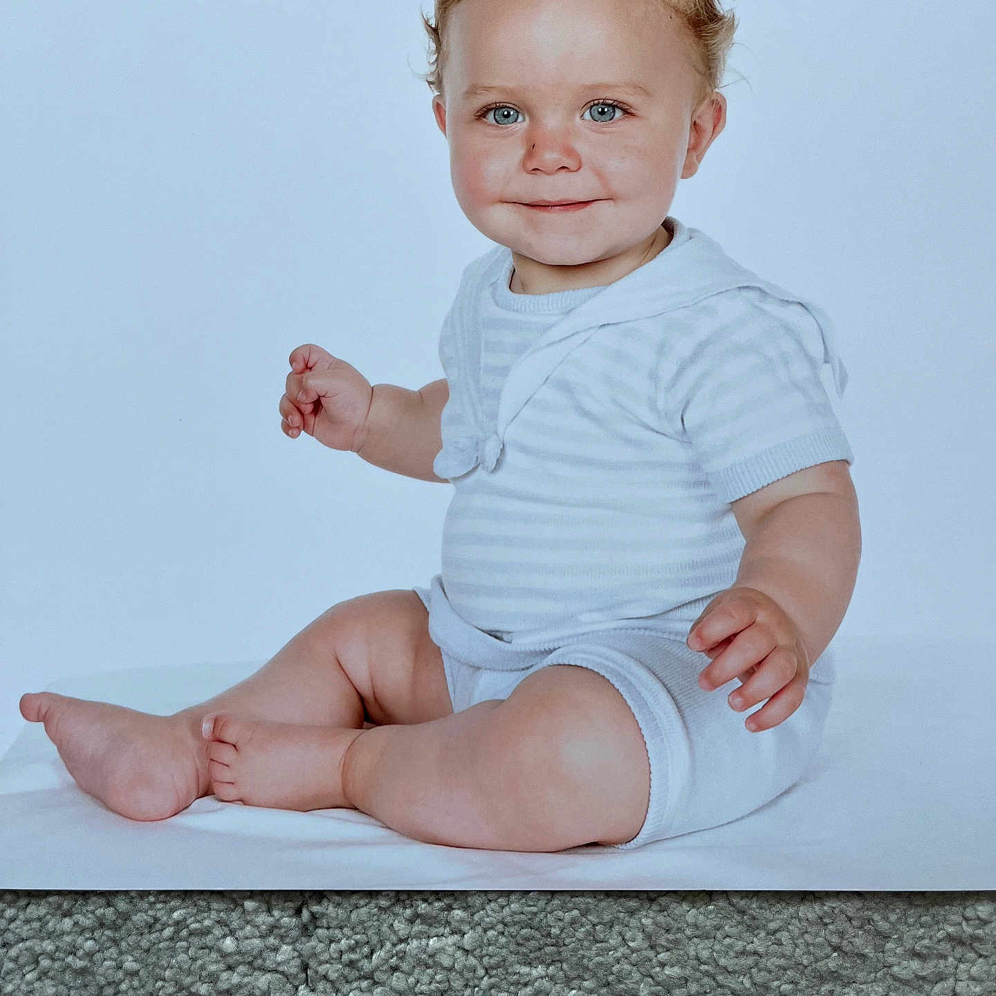 Harley is registered to the contest to win money with this photo: ankle, baby, blonde, bodypart, clothing, diaper, face, finger, hair, hand, happy, head, longsleeve, person, photography, portrait, sitting, sleeve, smile, wrist