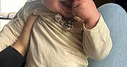 Rosalina is registered to the contest to win money with this photo: baby, child, infant, smiling, hand, leopard_print, clothing, long_sleeve, pants, person, indoor, window, light, happy, cute, skin, head, face, sitting, holding