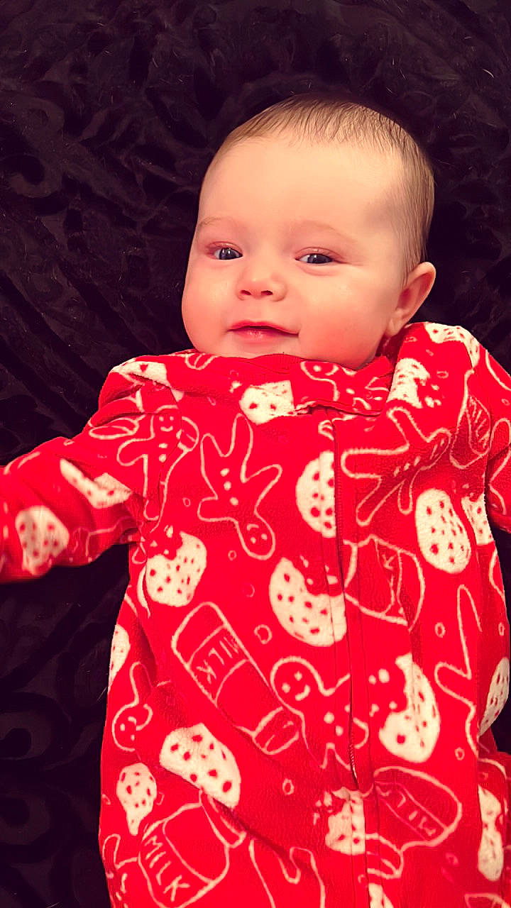 Kenzlee is registered to the contest to win money with this photo: baby, baby_toddler_clothing, cheek, chin, collar, gesture, human_body, lip, mammal, neck, nose, orange, outerwear, person, pink, product, skin, sleeve, smile, t_shirt