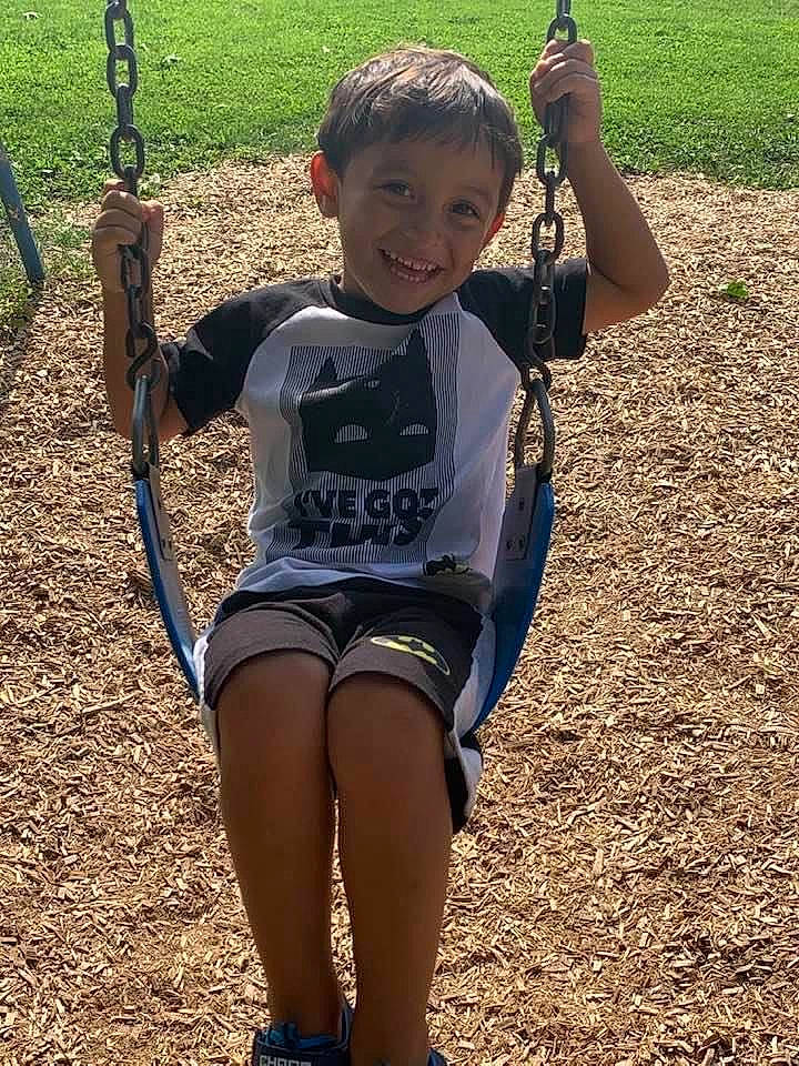 Justin is registered to the contest to win money with this photo: child, fun, joy, outdoor_play_equipment, person, play, playground, public_space, recreation, soil, swing, tree