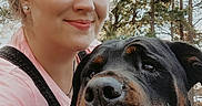 Jasmine joined the competition — help win amazing prizes! animal, black_dog, canine, casual_clothing, closeup, companion, daylight, dog, face, friendship, happy, nature, outdoor, person, pet, portrait, rottweiler, smile, trees, woman