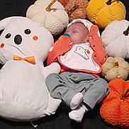 Aurora is registered to the contest to win money with this photo: baby, sleeping, plush_toy, ghost, pumpkins, halloween, costume, clothing, orange, white, grey_pants, cotton, soft_toys, decorations, festive, holiday, infant, pacifier, blanket, cute