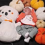 baby, sleeping, plush_toy, ghost, pumpkins, halloween, costume, clothing, orange, white, grey_pants, cotton, soft_toys, decorations, festive, holiday, infant, pacifier, blanket, cute