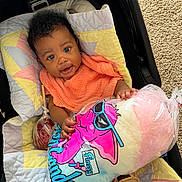Zoya is registered to the contest to win money with this photo: baby, child, cotton_candy, quilt, orange_bib, car_seat, colorful, smiling, happy, indoor, toy, food, pink, blue, yellow, fabric, footwear, person, portrait, cute