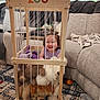 Fiadh joined the competition — help win amazing prizes! toddler, child, playpen, stuffed_animals, plush_toys, smiling, indoors, living_room, sofa, carpet, blanket, toy, couch, happy, wooden, furniture, person, cute, playtime, home