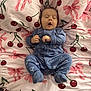 Zayn is registered to the contest to win money with this photo: baby, infant, sleepy, onesie, blue_clothing, dinosaur_pattern, bed, blanket, pink, cherry_pattern, bow_pattern, cute, lying_down, small_hands, closed_eyes, mouth_open, soft_fabric, cozy, indoor, child