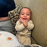 Theodore joined the competition — help win amazing prizes! baby, smiling, clapping, onesie, nike, couch, pillow, blanket, happy, infant, child, indoor, person, seated, cozy, cute, portrait, fabric, home, relaxed