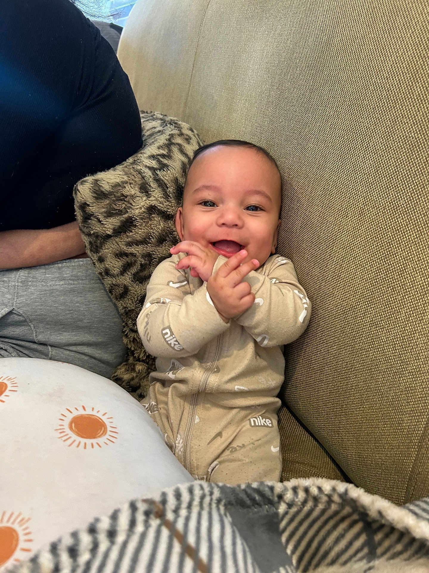 Theodore joined the competition — help win amazing prizes! baby, smiling, clapping, onesie, nike, couch, pillow, blanket, happy, infant, child, indoor, person, seated, cozy, cute, portrait, fabric, home, relaxed