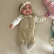 Rommy participe au concours pour gagner de l'argent avec cette photo : baby, infant, headband, romper, tights, lying_down, bed, plush_toy, pink, beige, white, baby_toy, container, soft, cute, child, indoor, portrait, clothing, smile