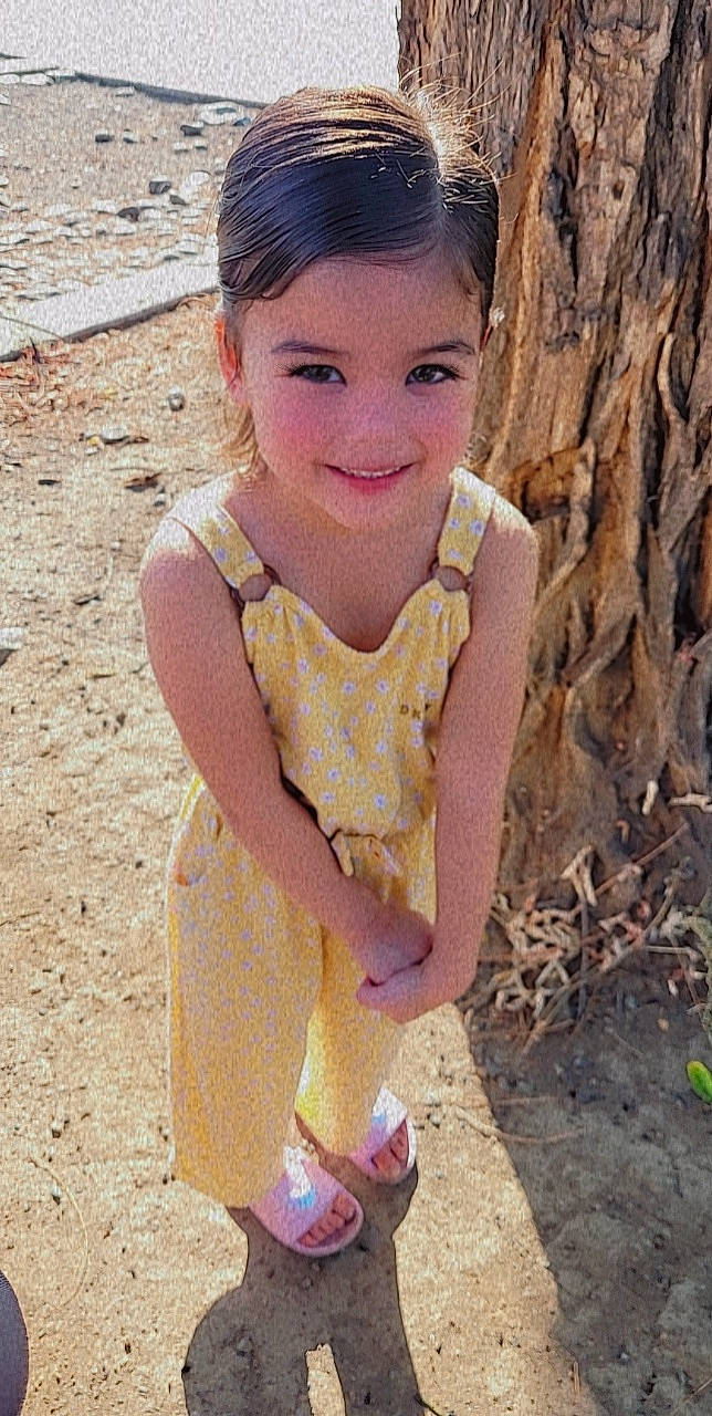 Kaliyah is registered to the contest to win money with this photo: facial_expression, fawn, fruit, fun, grass, hairstyle, hand, happy, head, joy, lip, neck, people_in_nature, person, pink, plant, skin, sleeve, smile, toddler