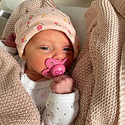 Romy participe au concours pour gagner de l'argent avec cette photo : newborn, baby, pacifier, pink, blanket, hat, infant, sleepy, wrapped, cute, knit, soft, clothing, hand, face, portrait, resting, indoors, cozy, small
