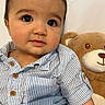 Daniel joined the competition — help win amazing prizes! baby, child, teddy_bear, stuffed_animal, blue_shirt, striped_shirt, cute, portrait, indoor, smile, person, face, infant, young_child, soft_toy, plush_toy, sitting, closeup, happy, adorable