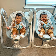 Daniel-Dariel joined the competition — help win amazing prizes! baby, baby_swing, carpet, child, clothing, cute, face, furniture, happy, indoor, infant, overalls, person, seatbelt, smile, striped_shirt, swing, toddler, toy_car, window