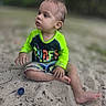 baby, child, toddler, beach, sand, outdoor, sitting, portrait, face, curious, looking_away, short_hair, green_shirt, surf_shirt, colorful_clothing, barefoot, legs, bottle_cap, blurred_background, daylight