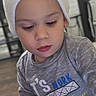 Geralt is registered to the contest to win money with this photo: child, toddler, baby, portrait, indoors, beanie, hat, gray_shirt, long_sleeves, tablet, technology, looking_down, curious, seated, face, eyes, lips, furniture, kitchen, casual_clothing