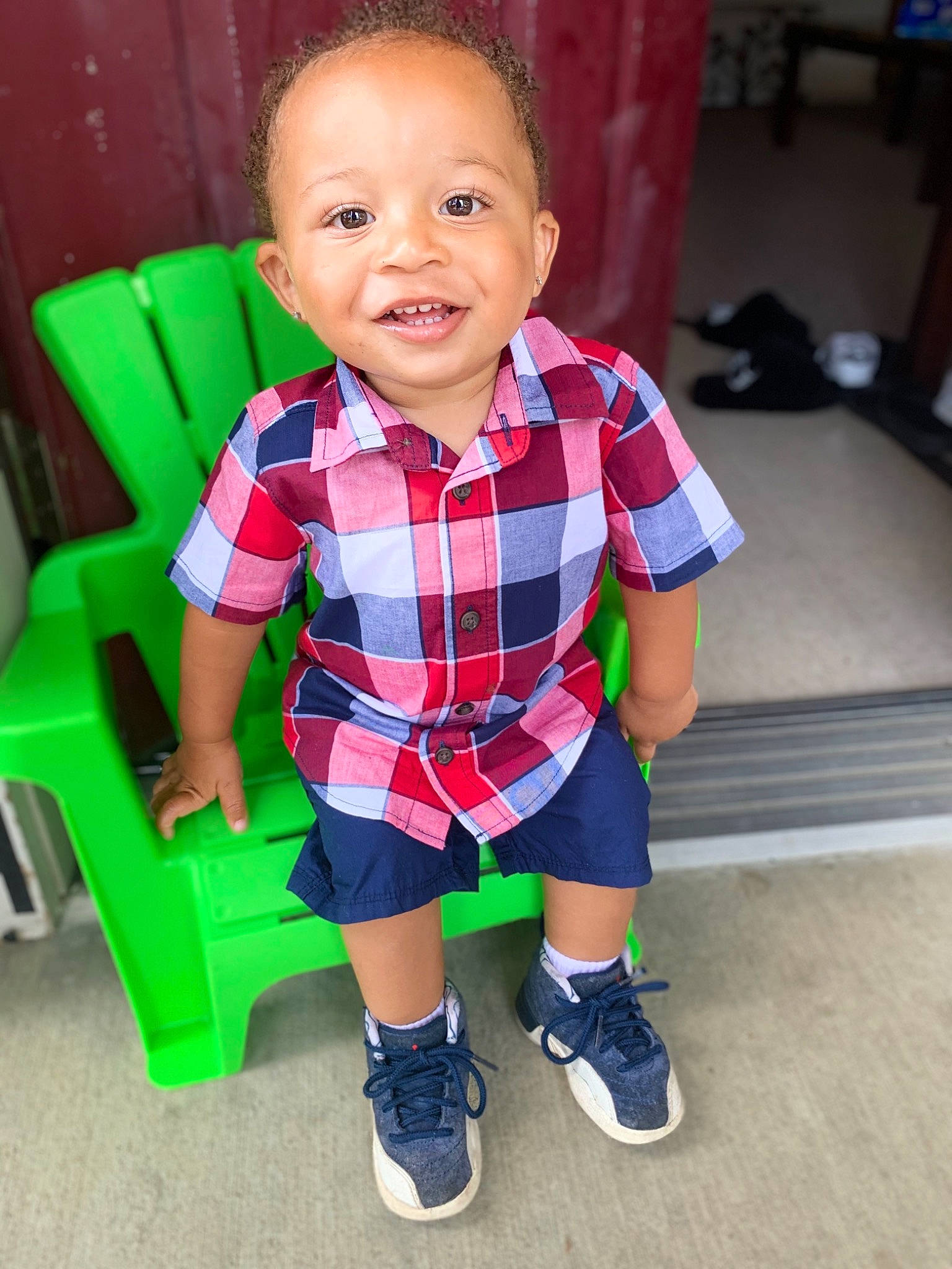 Hayden is registered to the contest to win money with this photo: baby, cheek, child, face, footwear, green, head, leg, pattern, person, play, shoe, sitting, skin, smile, standing, t_shirt, toddler