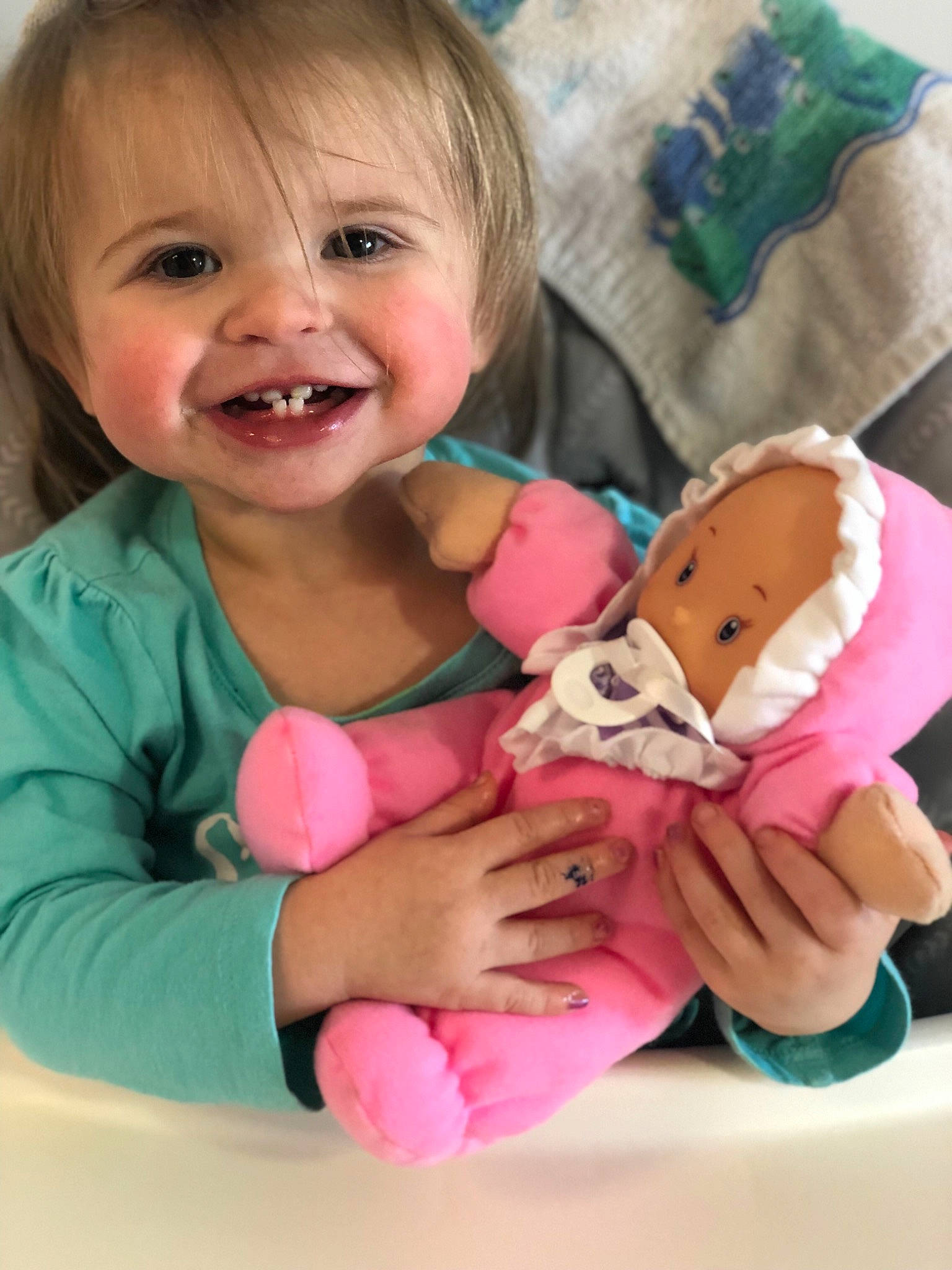 Oaklyn is registered to the contest to win money with this photo: baby, baby_products, baby_toys, brown_hair, cheek, child, doll, finger, hand, happy, joy, person, pink, play, plush, product, skin, smile, stuffed_toy, thumb
