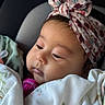 Leila is registered to the contest to win money with this photo: baby, infant, child, headband, blanket, car_seat, portrait, face, sleepy, cozy, closeup, cute, indoors, young_child, soft_light, patterned_clothing, resting, toddler, wearing, wrapped