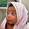 Leila is registered to the contest to win money with this photo: baby, towel, pink, face, child, indoor, curious, expression, skin, person, bathroom, shelf, container, moisture, soft, portrait, closeup, head, wrapped, cute