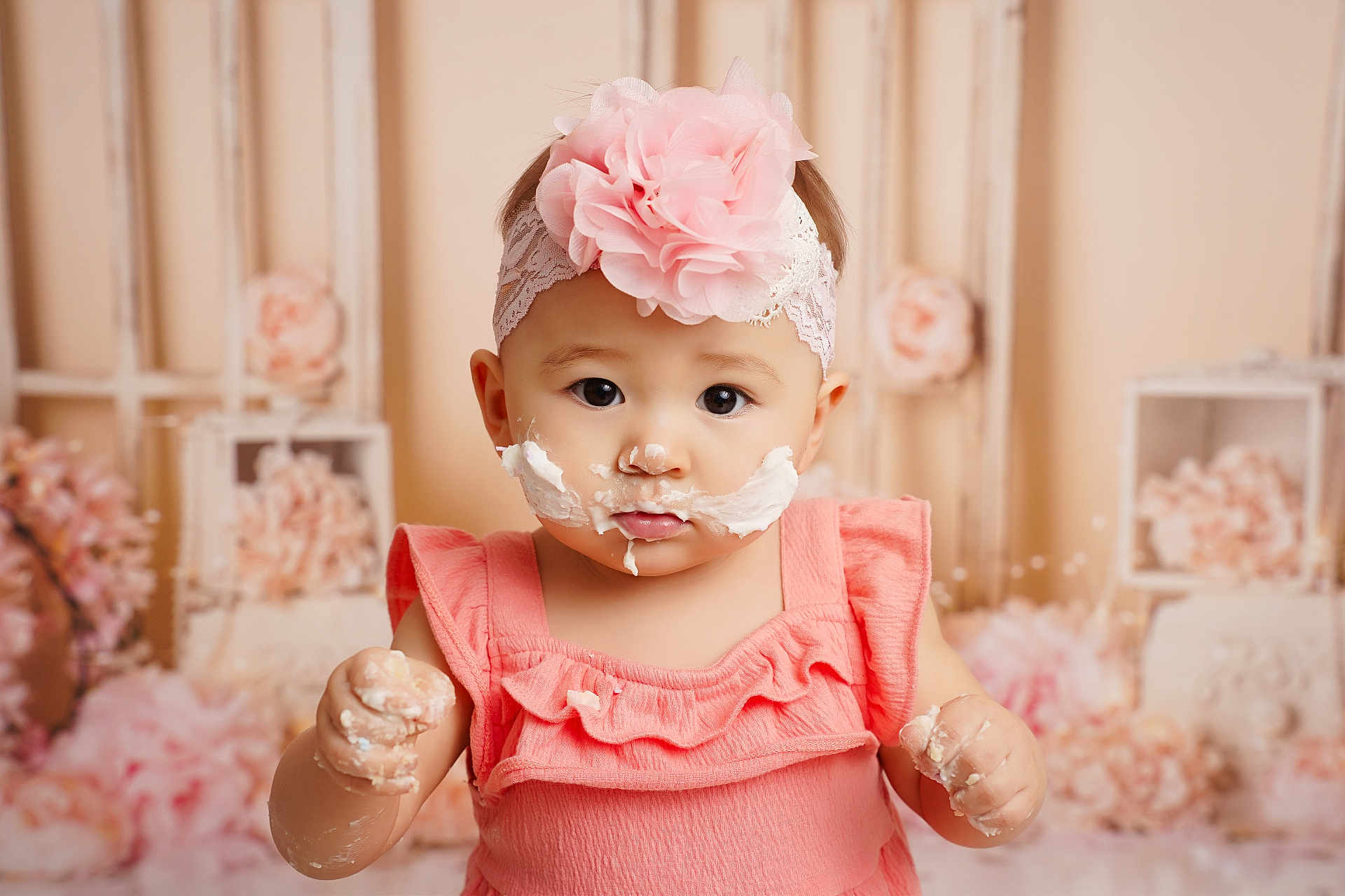 Charlotte joined the competition — help win amazing prizes! baby, child, girl, pink_dress, headband, flower, cake_frosting, messy, hands, face, portrait, indoor, decorations, soft_colors, cute, young_child, celebration, smiling, closeup, adorable