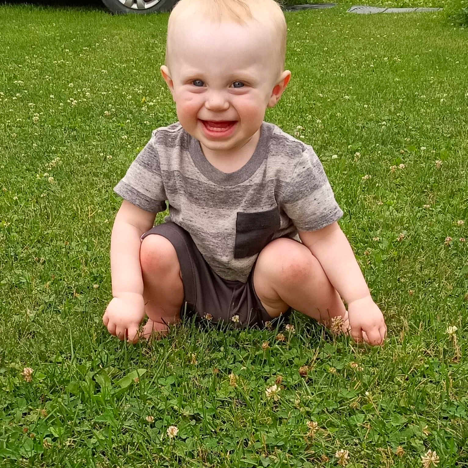 Elijah joined the competition — help win amazing prizes! alloywheel, baby, babylaughing, car, carwheel, face, grass, happy, head, lawn, machine, person, photography, plant, portrait, sitting, spoke, tire, transportation, wheel