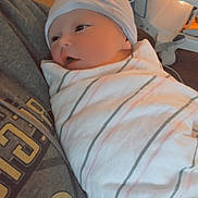 Bayleigh joined the competition — help win amazing prizes! newborn, baby, hospital, blanket, striped, hat, person, holding, medical_equipment, gaze, swaddled, infant, clothing, closeup, indoor, bedside, portrait, cute, cozy, rest