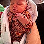 Bayleigh joined the competition — help win amazing prizes! newborn, baby, sleeping, blanket, onesie, headband, bow, floral_pattern, infant, cozy, person, hand, tattoo, skin, resting, soft, cute, closeup, indoor, peaceful