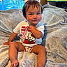 Ariella joined the competition — help win amazing prizes! toddler, child, baby, sitting, blanket, indoors, window, hair_bows, hello_kitty, cartoon, television, cute, playful, clothing, smile, face, legs, feet, furniture, room