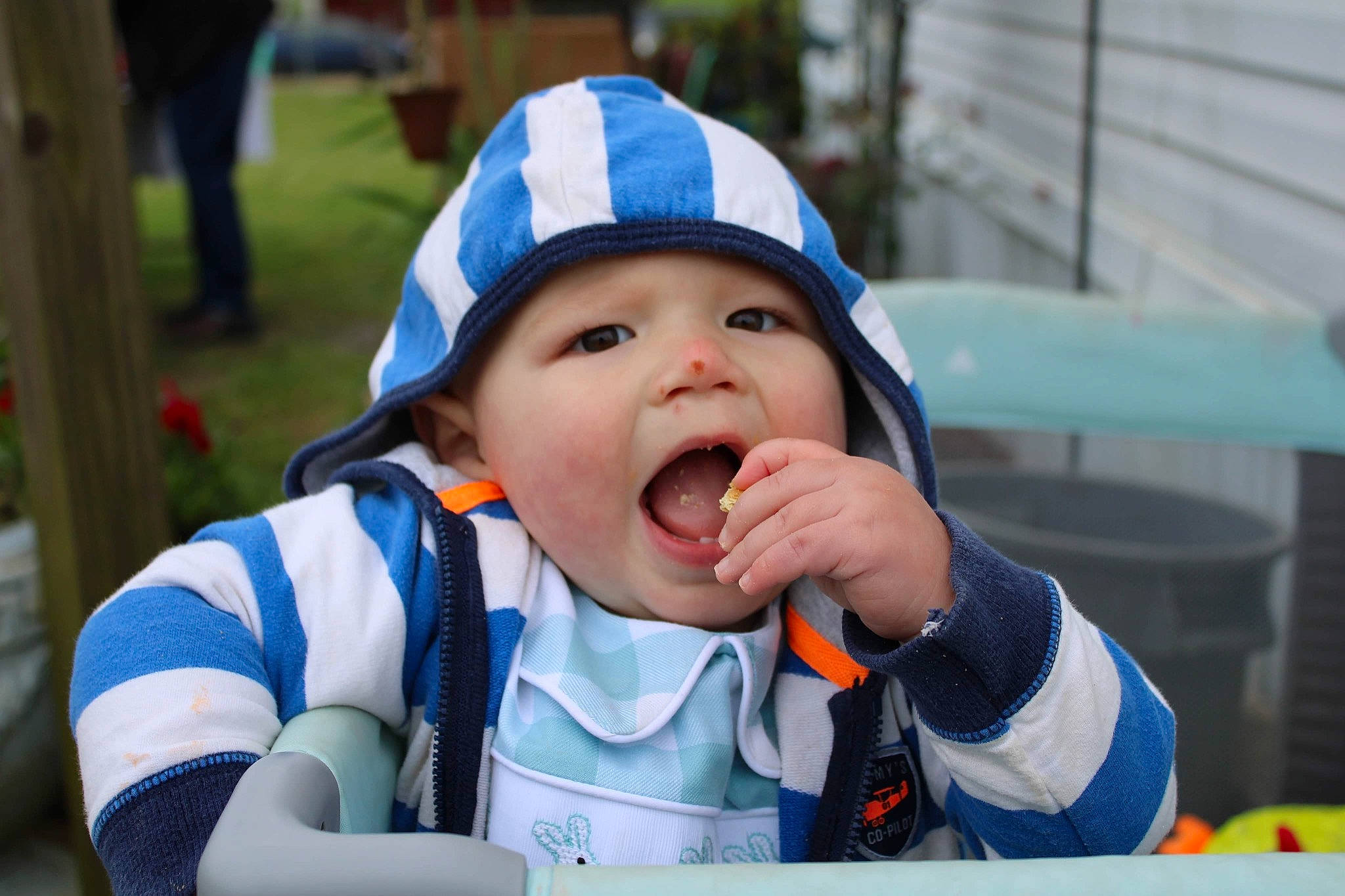 Keith is registered to the contest to win money with this photo: baby, baby_toddler_clothing, baseball_cap, cap, child, event, fun, grass, happy, hat, headwear, leisure, person, personal_protective_equipment, plant, recreation, sitting, toddler, vacation