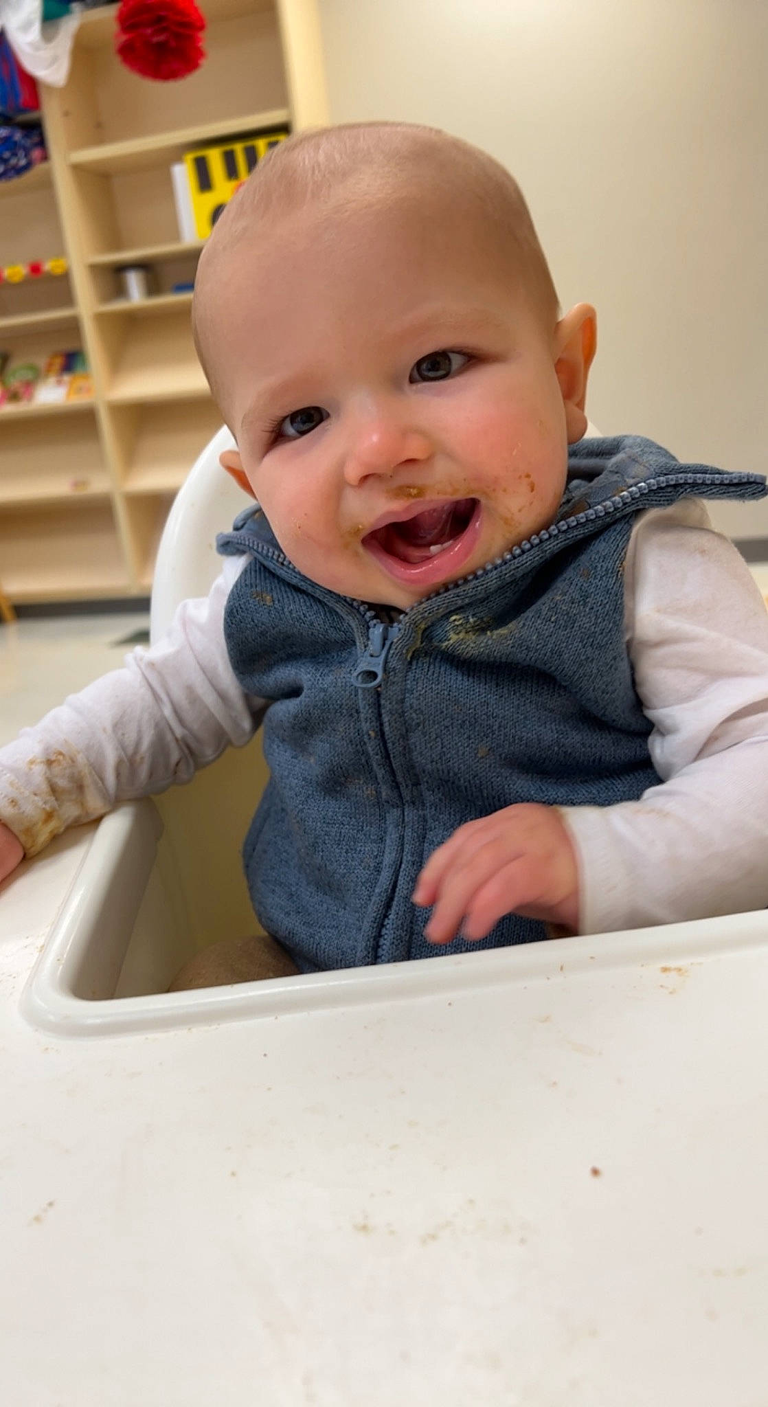 Keith joined the competition — help win amazing prizes! arm, baby, baby_toddler_clothing, bookcase, cheek, child, eye, finger, fun, happy, nose, outerwear, person, shelf, shelving, sitting, skin, sleeve, smile, t_shirt