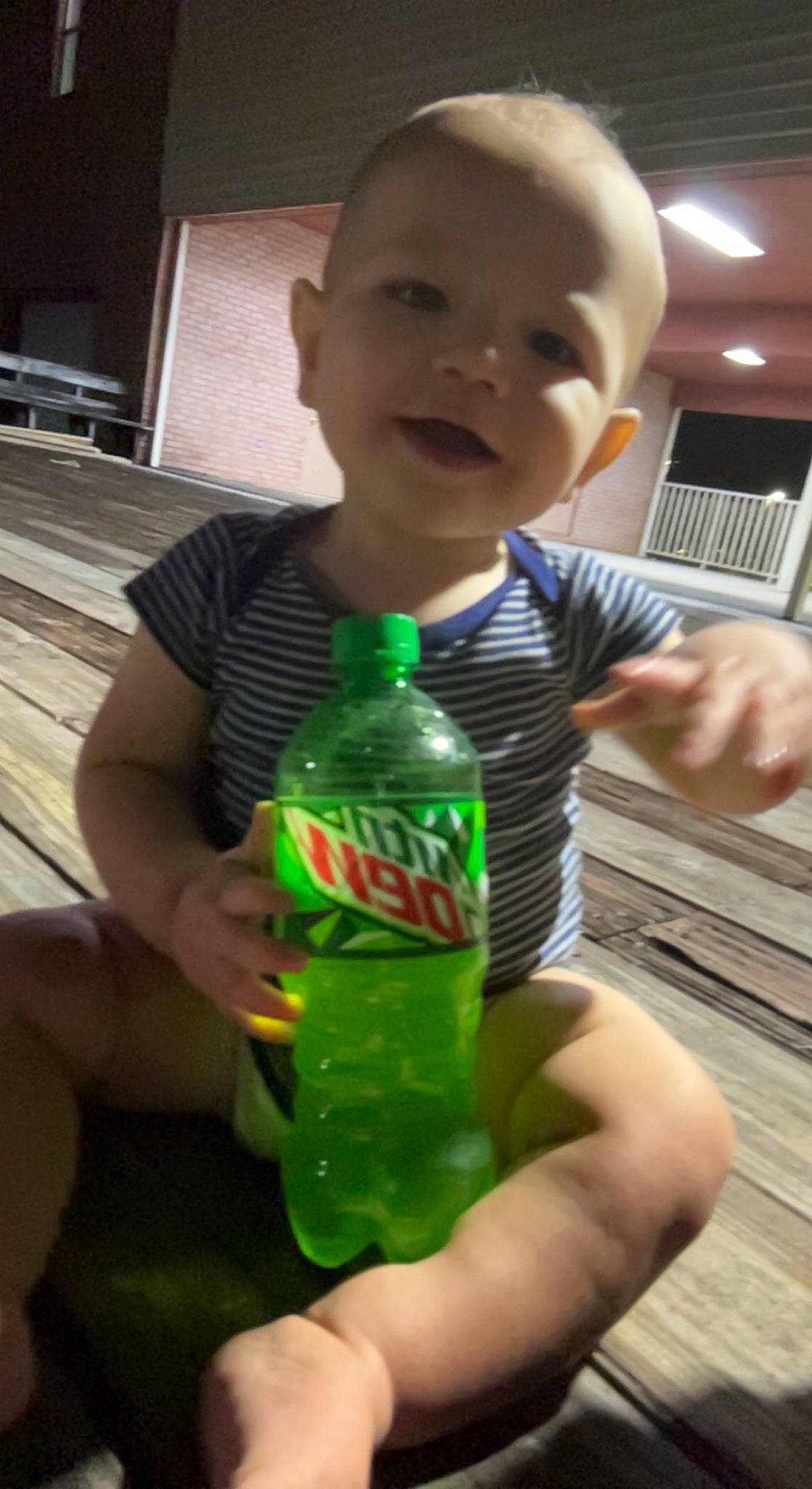 Keith is registered to the contest to win money with this photo: bottle, carbonated_soft_drinks, child, drink, drinkware, finger, fun, green, hand, happy, muscle, nail, person, photograph, plastic_bottle, smile, snapshot, soft_drink, standing, thumb