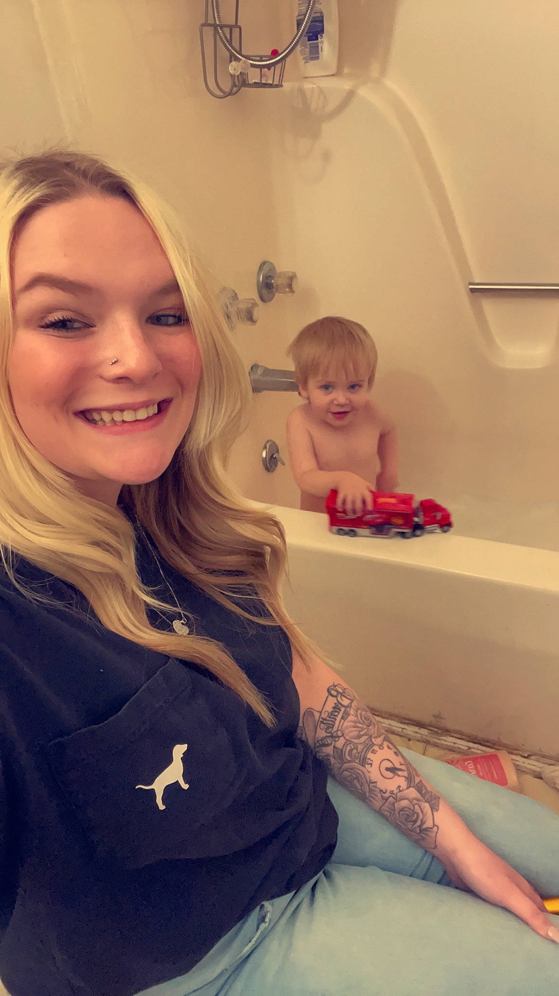 Brentley is registered to the contest to win money with this photo: bathing, bathroom, blond, brown_hair, child, elbow, eyebrow, eyelash, fun, happy, human_leg, joy, lip, long_hair, mouth, person, pink, plumbing_fixture, shoulder, skin