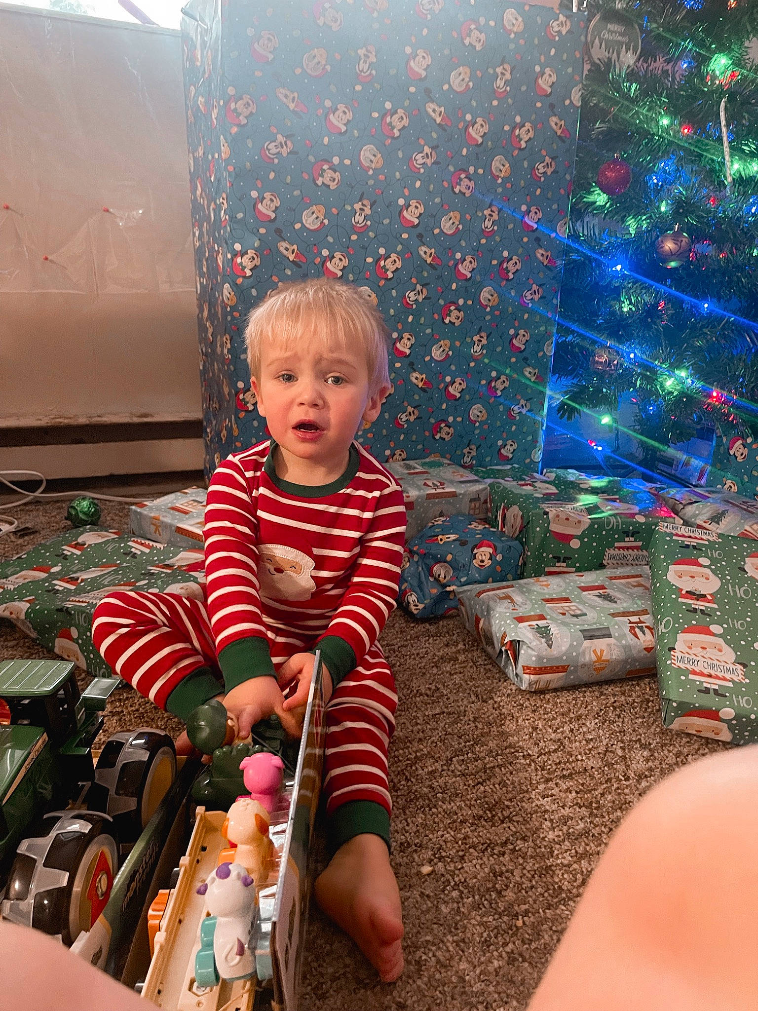 Brentley is registered to the contest to win money with this photo: baby, beauty, child, christmas_decoration, christmas_ornament, christmas_tree, event, fun, happy, holiday, lap, leisure, ornament, person, photograph, play, sitting, snapshot, standing, toddler