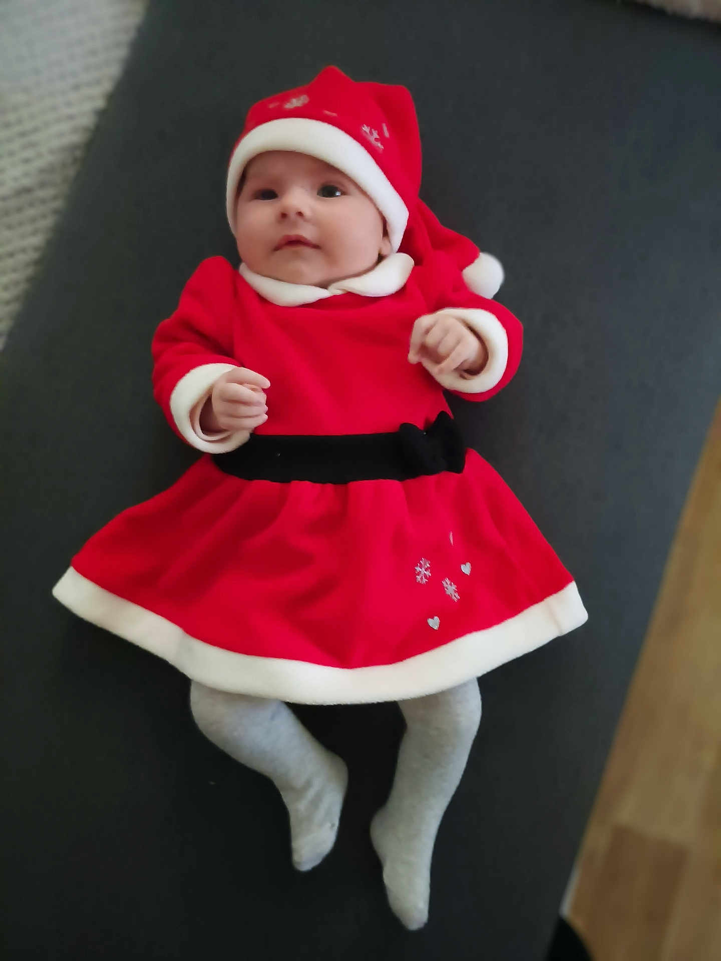 Liséa participe au concours pour gagner de l'argent avec cette photo : baby, infant, child, red_clothing, santa_hat, holiday_outfit, lying_down, grey_tights, cute, festive, indoor, carpet, floor, portrait, smiling, young_child, christmas, holiday, person, toddler