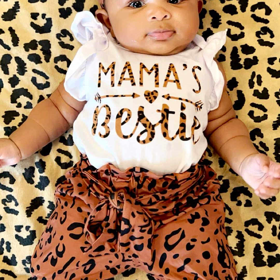 Ja'Nique is registered to the contest to win money with this photo: accessories, baby, bonnet, clothing, cushion, dress, face, hat, head, headband, homedecor, pants, person, photography, portrait, shorts, sitting, sleeve, t_shirt, toy