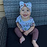 Zamira joined the competition — help win amazing prizes! baby, child, smiling, headband, blue_eyes, shirt, cartoon_print, pants, barefoot, outdoor_chair, woven_chair, happy, sitting, infant, cute, portrait, candid, sunlight, fun, fashion