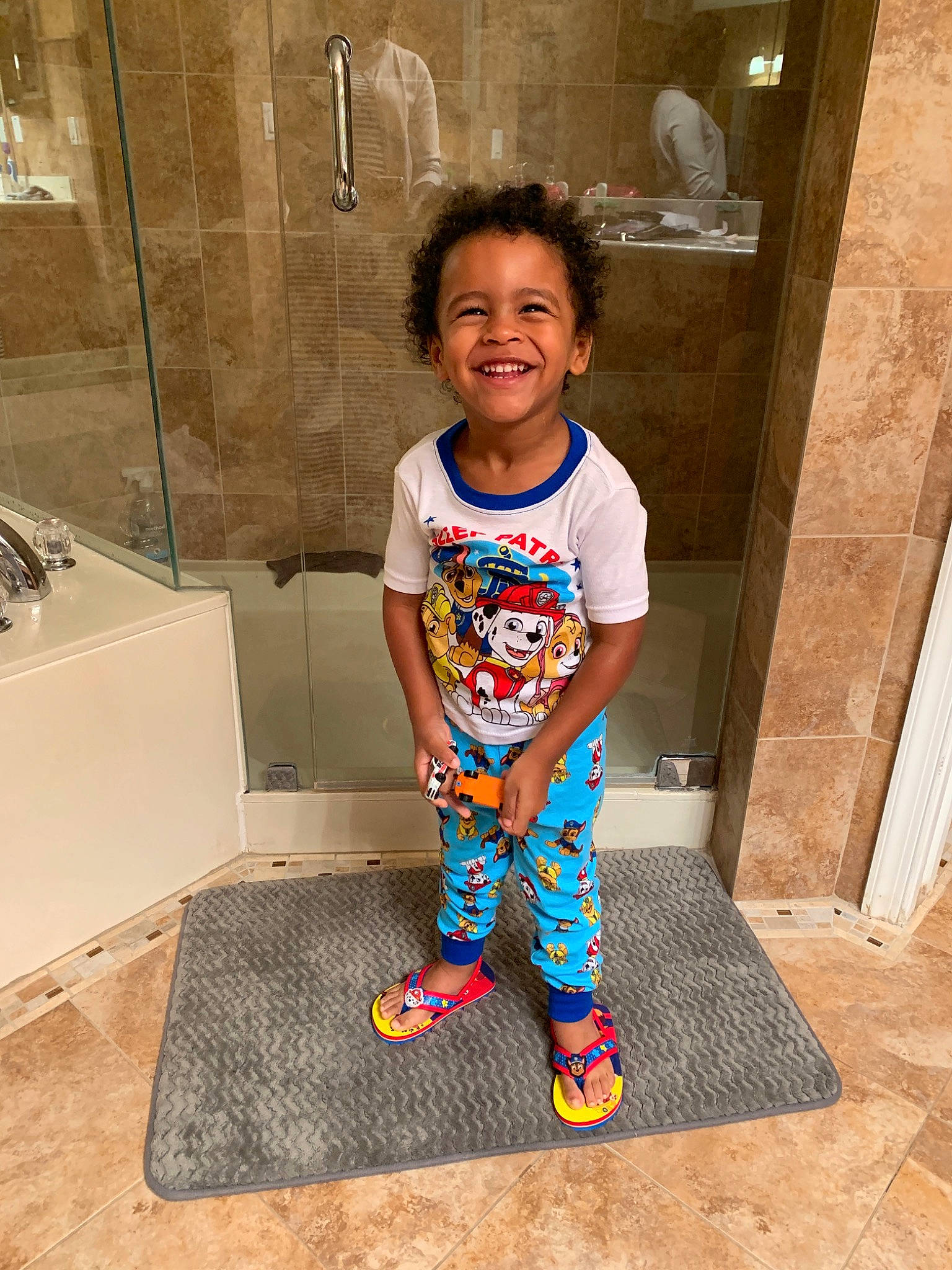 Mason is registered to the contest to win money with this photo: child, floor, flooring, joy, person, play, plumbing_fixture, smile, standing, tile, toddler, vacation