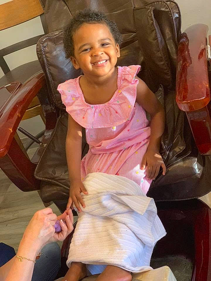 Madison is registered to the contest to win money with this photo: chair, child, daughter, fun, joy, leg, person, pink, sitting, smile, toddler