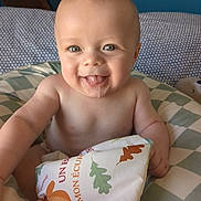 Alexandre a rejoint le concours — aidez-le/la à gagner de superbes lots ! baby, smiling, tongue_out, soft_book, cushion, indoor, child, cute, happy, portrait, infant, playful, colorful, toy, person, face, skin, head, bare_chest, background