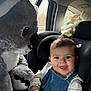 baby, car_interior, car_seat, car_window, child, child_safety, cute, denim_overalls, hair, happy, infant, koala, plush_toy, road_trip, seatbelt, smiling, soft_toy, toy, white_shirt, window