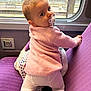 baby, child, pacifier, pink_sweater, white_tights, purple_seat, train, window, rain, climbing, curious, indoor, seat, travel, infant, candid, face, person, looking_back, cozy