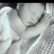 Legend is registered to the contest to win money with this photo: baby, sleeping, blanket, monochrome, soft_texture, peaceful, infant, closeup, face, hand, newborn, cocoon, rest, quiet, cozy, bedtime, skin, portrait, child, tender
