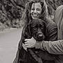 Milo joined the competition — help win amazing prizes! woman, dog, smiling, hugging, wet_dog, man, outdoor, black_and_white, happy, portrait, candid, pet, animal, people, love, nature, friendship, casual_clothing, warm_moment, affection