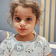 Selina joined the competition — help win amazing prizes! animal_print, casual, child, clothing, curly_hair, cute, earrings, expression, eyes, face, girl, indoor, person, portrait, shirt, sitting, striped_wall, toddler, wall, young