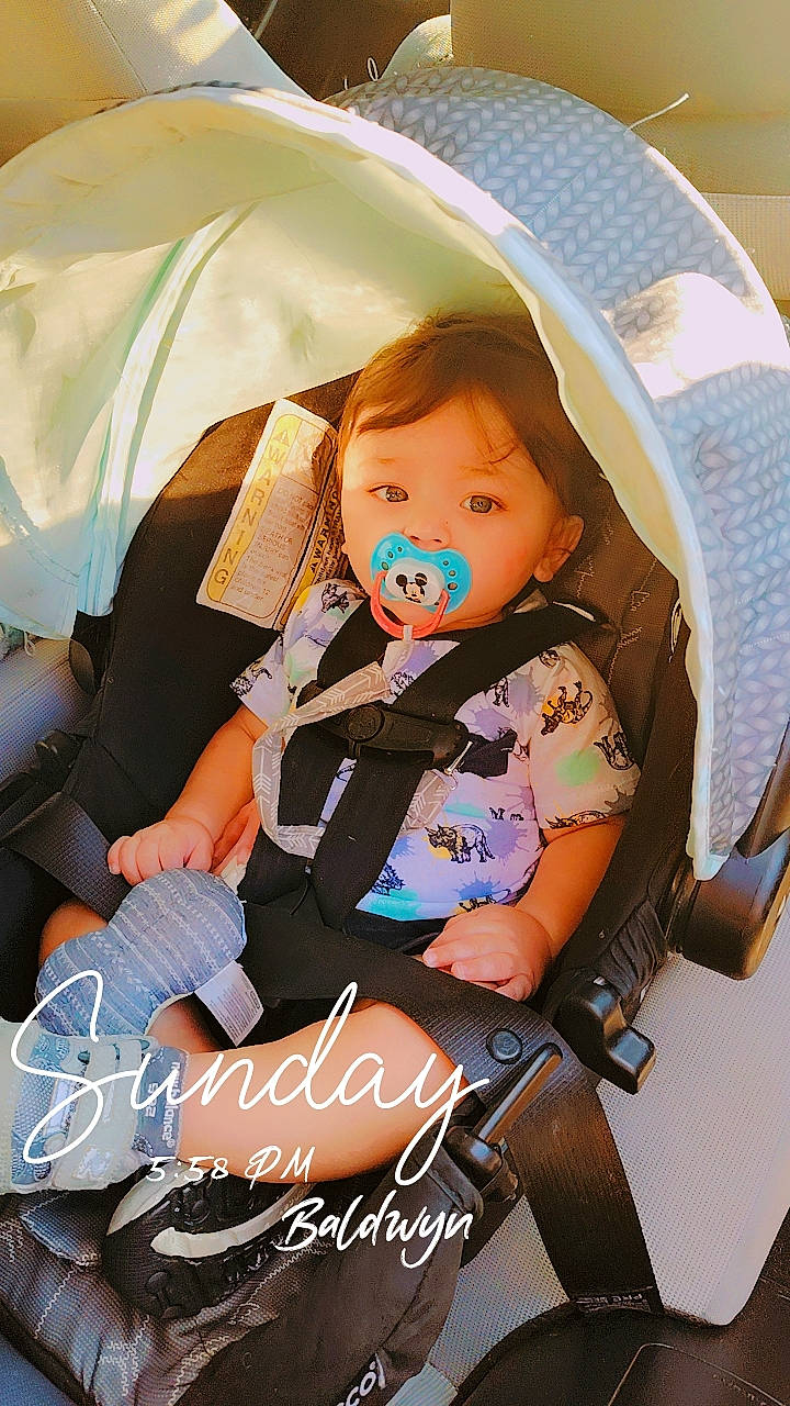 Josiah is registered to the contest to win money with this photo: auto_part, baby, baby_carriage, baby_products, baby_toddler_clothing, car_seat, car_seat_cover, child, comfort, doll, fashion_accessory, lap, pattern, person, plush, product, sitting, stuffed_toy, thigh, toddler