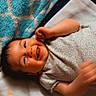 baby, infant, child, smiling, laughing, lying_down, bed, blanket, pillow, bedding, portrait, face, eyes, hands, fist, onesie, indoors, cozy, happy, date_stamp