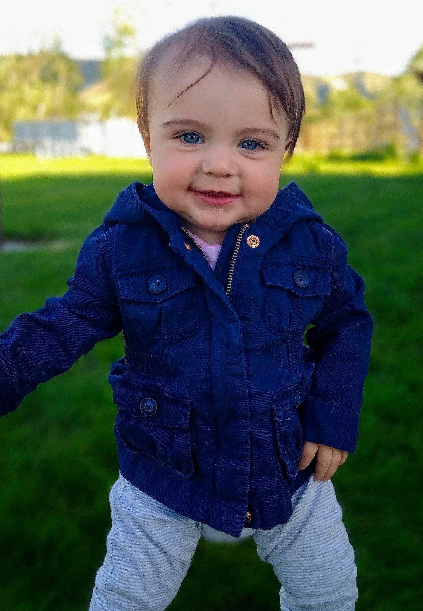 Halle joined the competition — help win amazing prizes! baby, blue, cheek, child, cool, eye, face, facial_expression, grass, green, head, jacket, leaf, outerwear, people, person, photography, skin, smile, standing