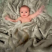 Ayden joined the competition — help win amazing prizes! baby, blanket, arms, waving, soft, cozy, curious, face, infant, child, texture, fabric, wrapped, bed, comfort, cute, young, motion_blur, skin, lying_down