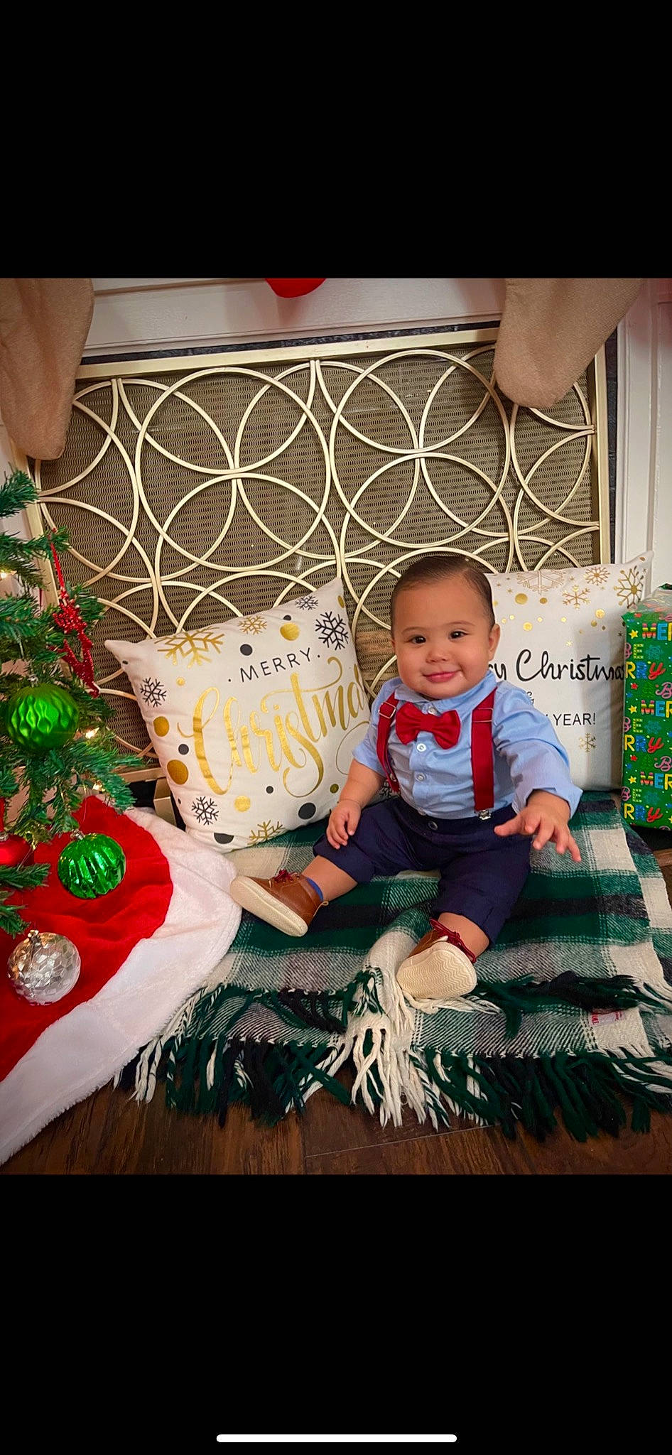 Xavier is registered to the contest to win money with this photo: baby, baby_toddler_clothing, child, christmas_decoration, christmas_eve, christmas_ornament, christmas_tree, dress, event, green, happy, holiday, joy, pattern, person, product, sitting, smile, t_shirt, toddler